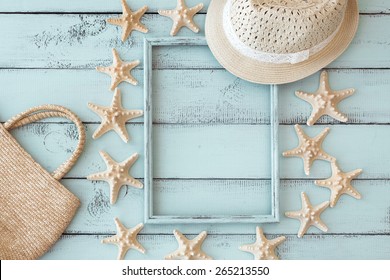 Summer Beach Decoration: Starfishes Photo Frame With Straw Hat And Handbag On Mint Wooden Background