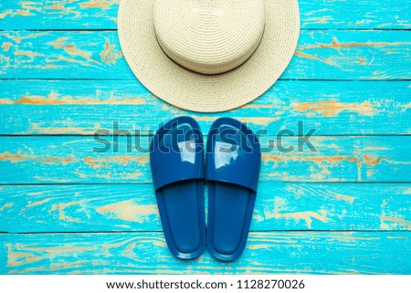 Summer beach flip flops on colored background