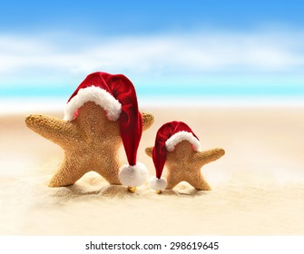 Summer beach. Merry Christmas. Starfish in Santa Claus hat. - Powered by Shutterstock