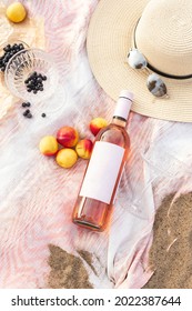 Summer Beach Picnic On The Coast. Bottle Of Rose Wine, Fruits, Summer Accessories. Romantic Party Concept. Top View - Image