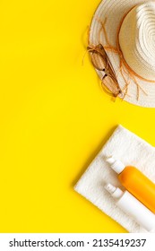 Summer Beach Vacation Concept With Straw Hat And Bottles Od Sunscreen