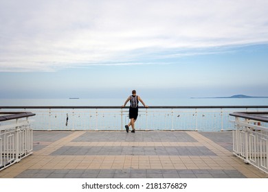 Summer In Beautiful Burgas City In Bulgaria. Landscape With Pier Above The Sea With Young Male Tourist.