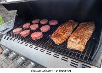 Summer Beef Hamburger And Pork Ribs BBQ On A Propane Gas Grill