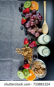 summer berries, grape, kiwi, orange  , granola , bottle of milk, flat lay of healthy breakfast with copy space - Shutterstock ID 710881324
