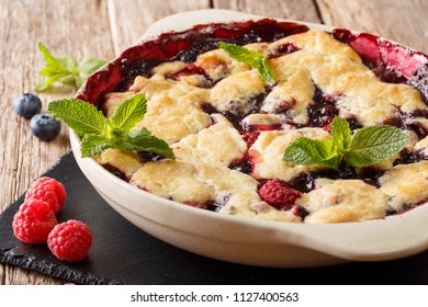 Summer Berry Cobbler Of Raspberries And Blueberries Close Up In A Dish Baking Dish On The Table. Horizontal
