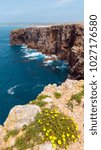 Summer blossoming Atlantic rocky coast view, Aljezur, Algarve west, Costa Vicentina, Portugal. People unrecognizable.