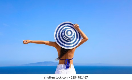 Summer blue trend with young woman in hat at  happy freedom lifestyle in Aegean sea mediterranean at Santorini,greece - Shutterstock ID 2154981467