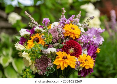 Summer bouquet. Beautiful multi colored fresh flower arrangement. Birthday bouquet made of summer flowers photographed outdoors. - Powered by Shutterstock