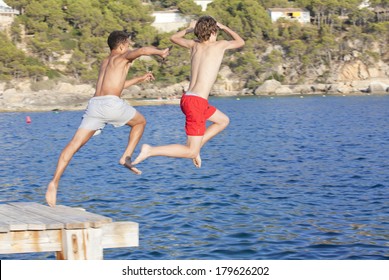 Summer Camp Kids Jumping In Sea