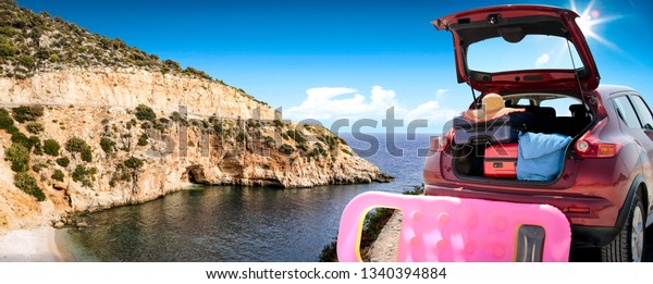 Summer car and landscape with sea
and sun . Red car with suitcase. Free space for your text.
