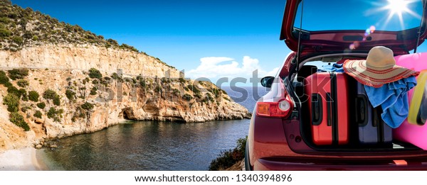 Summer car and landscape with sea
and sun . Red car with suitcase. Free space for your text.
