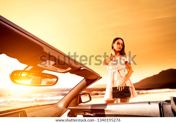 Summer car and slim young woman in
dress. Free space for your decoration and sunset time.
