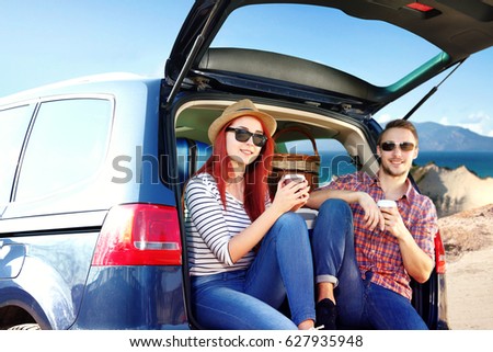 Similar – Two young women resting sitting inside of car