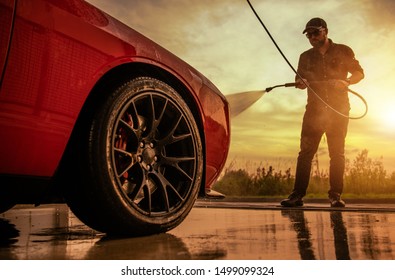 Summer Car Washing. Caucasian Men In His 30s Cleaning His Vehicle During Scenic Sunset.