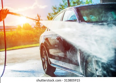 Summer Car Washing. Cleaning Car Using High Pressure Water. 