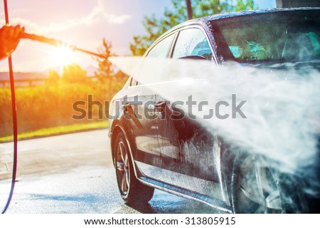 Summer Car Washing. Cleaning Car Using High Pressure Water. 