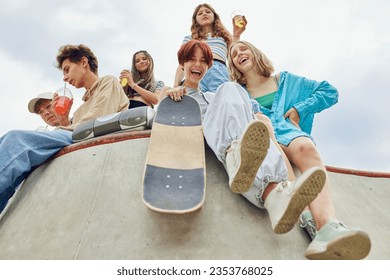 Summer chilling out. Friends, teenagers meeting on skatepark, drinking soda, talking, skateboarding and having fun. Concept of youth culture, sport, extreme, hobby, action and motion, friendship - Powered by Shutterstock