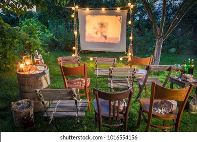 Summer cinema with retro projector in the garden