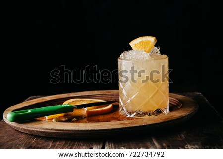 A summer citrusy cocktail on dark background