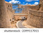 Summer cityscape - view of the bridge between the Revelin Fortress and the Ploce Gate in the Old Town of Dubrovnik on the Adriatic coast of Croatia