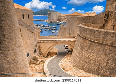 Summer cityscape - view of the bridge between the Revelin Fortress and the Ploce Gate in the Old Town of Dubrovnik on the Adriatic coast of Croatia - Powered by Shutterstock