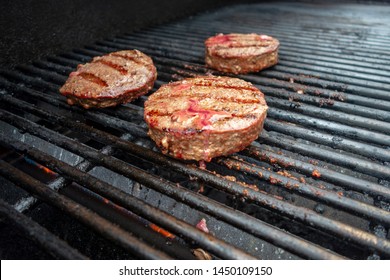 Summer Close Up Beef Hamburger BBQ On A Propane Gas Grill