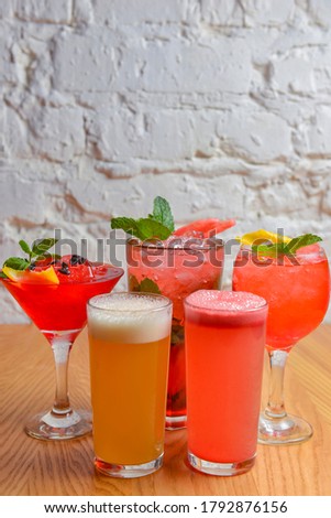 Summer cocktails and soft drinks with pieces of fruit on wooden table. Refreshing summer beverage for hot weather. Delicious cold drink with mint. Copy space banner.