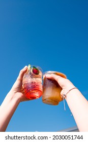 Summer Coffee Cocktail And Strawberry Lemonade. Happy Friends Toasting With Refreshing Drinks Under Blue Sky On Summer Day