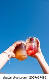 Summer Coffee Cocktail And Strawberry Lemonade. Happy Friends Toasting With Refreshing Drinks Under Blue Sky On Summer Day