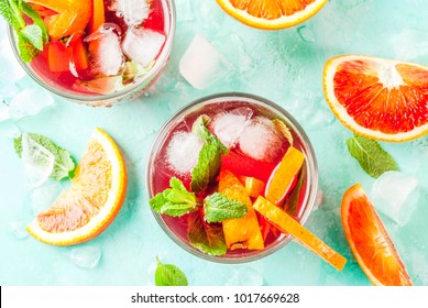 Summer Cold Drink, Blood Orange Mint Cocktail - Mimosa, Mojito Or Sangria,  Light Blue Background, Copy Space Top View