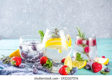 Summer Cold Drink Concept. Fruit And Berries Gin Tonic Cocktail, Or Infused Water Lemonade Mocktails, With Fresh Blueberry, Raspberry, Lemon And Herbs, Blue Green Old Wooden Background Copy Space