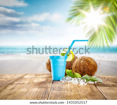 Summer cold drink and landscape of beach with palm. Sunny hot day and summer time 
