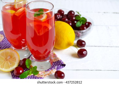 Summer Cold Drink - Lemonade With A Cherry On A White Background