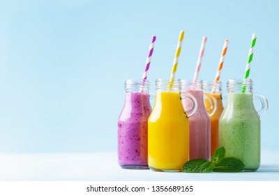 Summer Colorful Fruit Smoothies In Jars On Blue Background. Healthy, Detox And Diet Food Concept. 