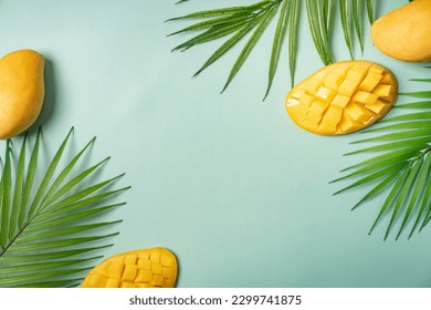 Summer colorfull concept with tropical fruits and leaves on green background, flat lay, top view, copy space - Powered by Shutterstock