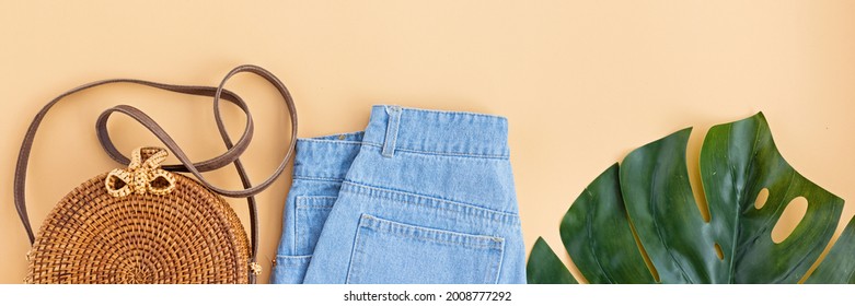 Summer Composition With Female Fashion Outfit. Monstera Leaves, Bamboo Bag, Shoes On Pastel Orange Background. Flat Lay, Top View, Overhead, Mockup, Template, Copy Space