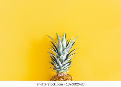 Summer composition. Pineapple on yellow background. Summer concept. Flat lay, top view