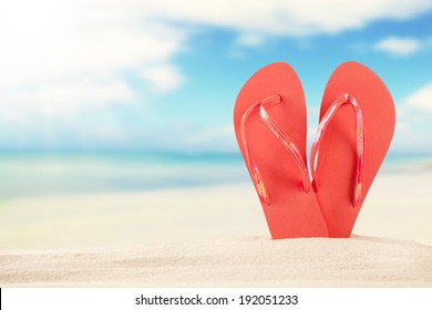 Summer Concept With Sandy Beach And Red Sandals