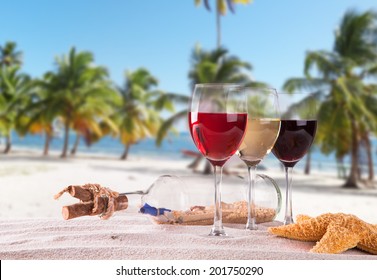 Summer Concept With Sandy Beach, Shells And Wine Drink 