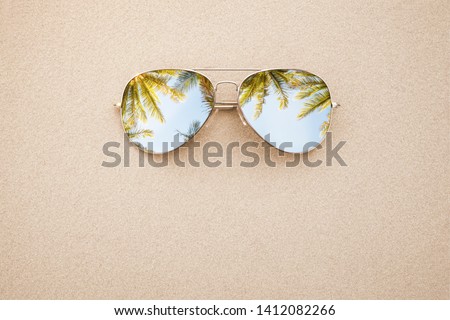 Summer concept, sunglasses in the sand, on the beach with copy space