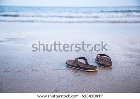 Summer concept.Flip flops on a sandy ocean beach