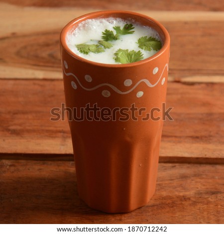 Summer cooler Buttermilk drink. Made of yogurt. served in a traditional clay pot, selective focus on top