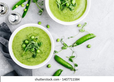 Summer cream soup with green fresh pea shoots. Top view