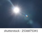 Summer Day Brilliant Sunshine Bursts Through Cloudless in a Vibrant Blue Sky. White shining blue sky without clouds good weather. Sun light flare on sky background. sunny background with sunbeams