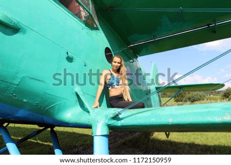 Summer day. Girl and airplane.