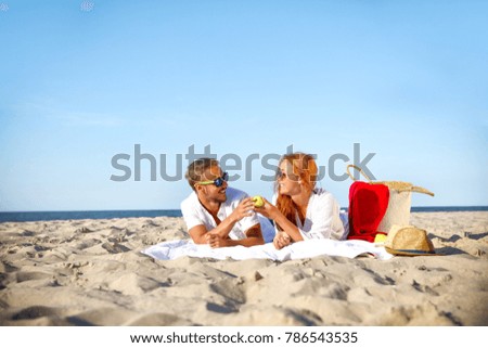Summer day on beach and two young lovers 