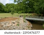 Summer day. Pedestrian bridge over Green Mill Run creek, Elm Street Park on East Carolina Universityâ€™s campus. Greenville, North Carolina