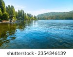 Summer day view of lakefront homes and docks at lower Twin Lakes, an 850 acre lake in the small suburban town of Twin Lake, Idaho, a suburb of the general Coeur d