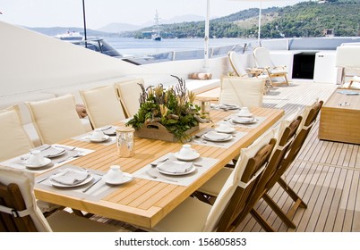 Summer day yacht deck with served table