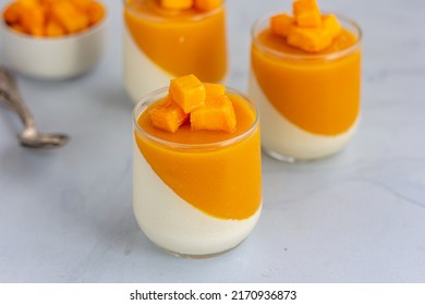 Summer Dessert Mango Panna Cotta in the Glasses with Fresh Mango Cubes Close Up Photo - Powered by Shutterstock